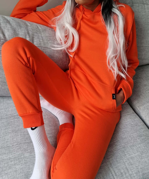 Orange hoodie Australian fashion designer. fashion week in a hoodie. Misha world hoodie. casual stay home. til Tok trends. work from home outfit. after pay available in madola the label.